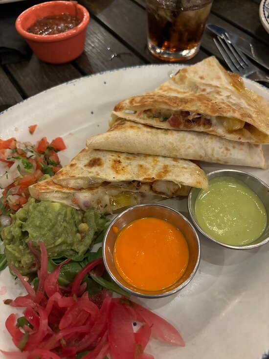 Meso Maya signature dishes Cochinita Pibil (Yucatan-style slow-roasted pork), Mole Poblano, Budin Azteca (corn tortilla casserole), Avocado Margarita, various ceviches.